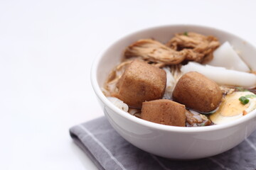 Thai food, Chinese roll noodle soup served in white cups on a white table.