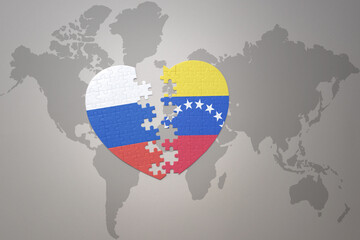 puzzle heart with the national flag of russia and venezuela on a world map background. Concept.