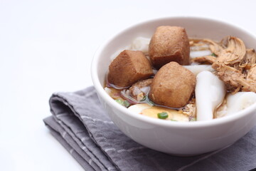 Thai food, Chinese roll noodle soup served in white cups on a white table.