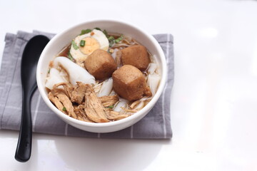 Thai food, Chinese roll noodle soup served in white cups on a white table.