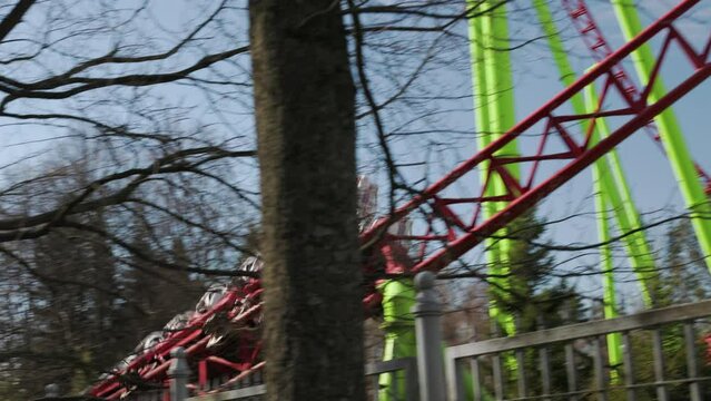 roller coaster, people ride and have fun in the park on a weekend