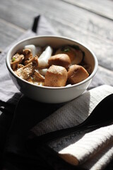 Thai food, Chinese roll noodle soup served in a white cup on a black wooden table.