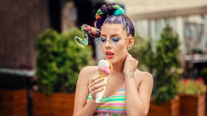 Fashion cool girl eating ice cream on street during summer vacation