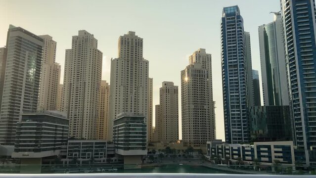 Beautiful cityscape. Dubai marina area, many skyscrapers at sunset. Embankment of the Persian Gulf. Concept travel to the united arab emirates. Slow motion. 