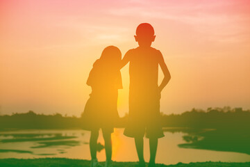 Fototapeta premium kid silhouette,Moments of the child's joy. On the Nature sunset