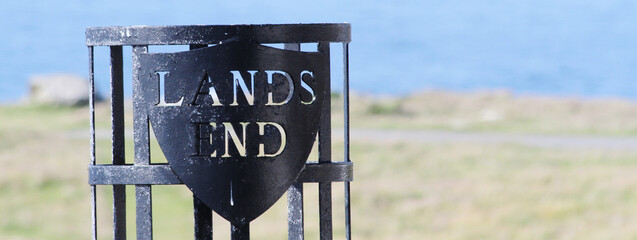Fototapeta Horizontal banner or header with Land's End sign, mainland Britain’s most south-westerly point. Bright filter with focus on the sign at left obraz