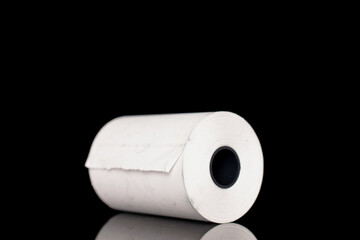One roll of paper cash tape, close-up isolated on black.