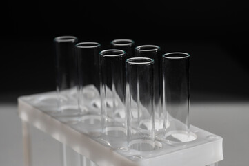 Empty test tubes in a rack on a white background.