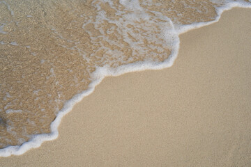 Close-up of the golden sand, washed by the gentle waves of the sea. Cala Mesquida, Majorca Spain