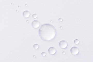 Water drops on white background. Abstract drops of gel. Face serum cosmetics. - 506477058