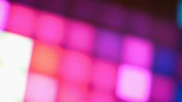 Abstract blurred background of glowing multicolored squares