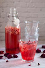 Fototapeta na wymiar glass of rose Kombucha with iced on white table ,fermented tea drink, healthy beverage.