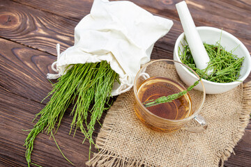 Bag of horsetail. cup of tea from horsetail, made from fresh potion, from pharmacy mortar....