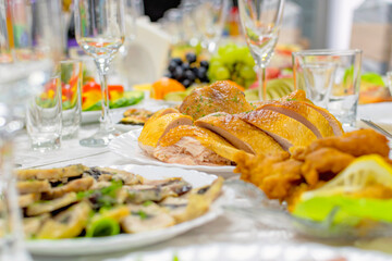 A festively decorated banquet table with delicious and healthy food and wine glasses.