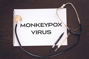 Monkeypox virus on notebook  with stethoscope