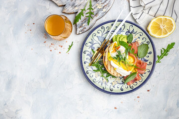 Healthy nutritious paleo keto breakfast diet avocado and Poached Egg, cheese, salmon and fresh salad, fresh juice, Keto breakfast or lunch. place for text, top view