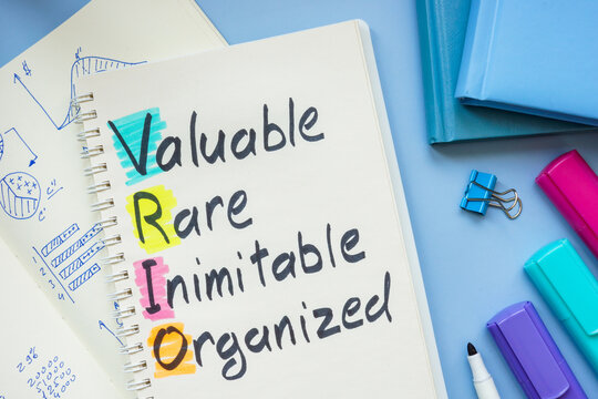 Notebook with VRIO Analysis on the desk.