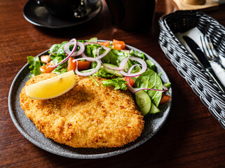 schnitzel with fresh sald and lemon