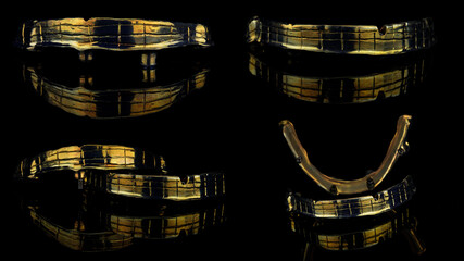 photo collage dental bar made of titanium in gold color for two prostheses on a black background with reflection