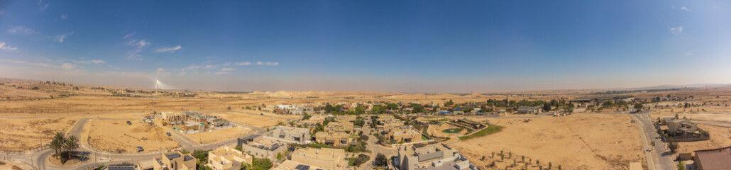 Fototapeta na wymiar 180 dgree panorama from the sky over the roofs Tlalim village of Negev desert