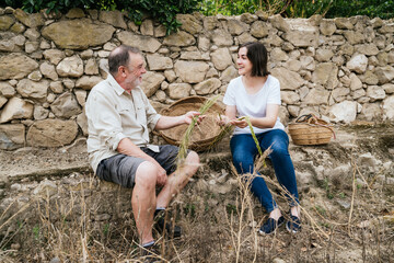 Happy woman with father holding halfah grass for natural fiber crafts