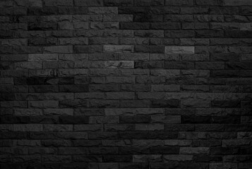black brick wall background, dark stone texture.	