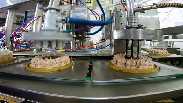 The process of creating a cake on a conveyor line. Modern confectionery factory. Cake on an automated conveyor line