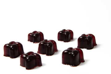 Dark red cherry homemade gelatin candy on white background