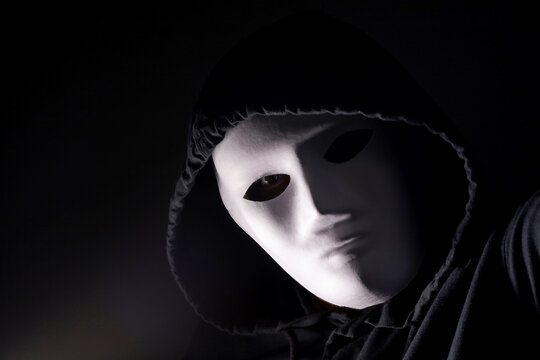 portrait of a person with a mask on a dark background