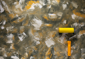 Paint roller at abstract putty background. Tool construction or art concept and wall texture
