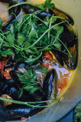 steamed mussels in a pot with white wine, Italian parsley, tomato