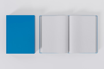 Mockup of two rectangular books with blank, blue glossy covers on white background. Both closed and open. Isolated with clipping path.