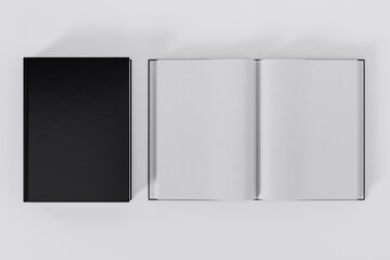 Mockup of two rectangular books with blank, black glossy covers on white background. Both closed and open. Isolated with clipping path.