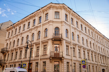 Saint Petersburg, Russia, 18 October 2021: Profitable House in classical style, street have memories about Fyodor Dostoevsky, House five corners at sunny autumn day, Crime and Punishment atmosphere