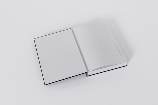 Mockup of a rectangular open on the first-page book with a blank, black glossy cover on white background. Isolated with clipping path.