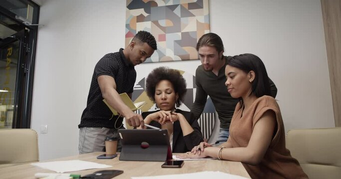 Diverse colleagues working on project together