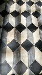 black and white tile floor making a checkerboard effect in three dimensions