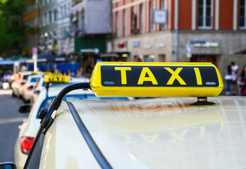 Taxi signs in a row. Taxi sign on car roof. Transportation. Cabs in the city. Taxi stand. 