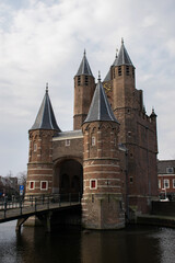 Fototapeta na wymiar Historic city gateway at Haarlem in the netherlands. Famous travel destination. National monument. Defensive construction building. 