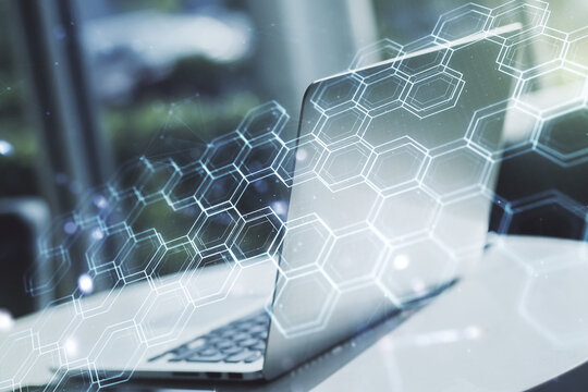 Double exposure of technology hologram with hexagon on laptop background. Research and development software concept