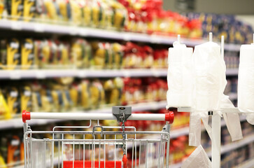 choosing a dairy products at supermarket.empty grocery cart in an empty supermarket