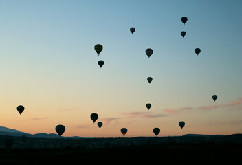 View of the city of Goreme with caves and air baloons in Cappadocia. Fabulous landscapes of the mountains of Cappadocia Goreme, Turkey