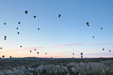 View of the city of Goreme with caves and air baloons in Cappadocia. Fabulous landscapes of the mountains of Cappadocia Goreme, Turkey