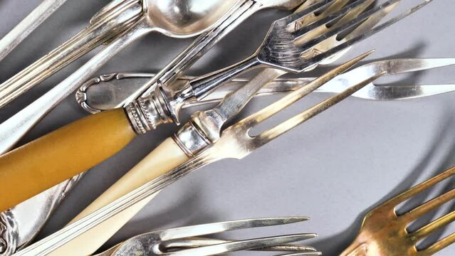 Old kitchen silverware on a bright, colored background