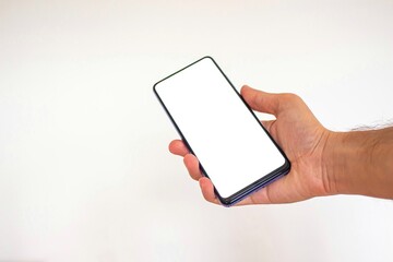 Hand holding phone with blank screen on isolated white background.