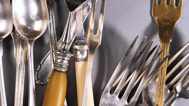 Old kitchen silverware on a bright, colored background