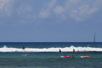 Surfers tackle the waves on Waikiki Beach, Honolulu, Hawaii.
