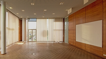 Empty director`s office with parquet, wooden wall and big windows in the former city library of...