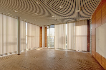 Empty director`s office with parquet, wooden wall and big windows in the former city library of Ghent, Belgium 