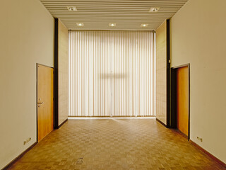 Empty  office with parquet, wooden wall and big windows in the former city library of Ghent, Belgium 
